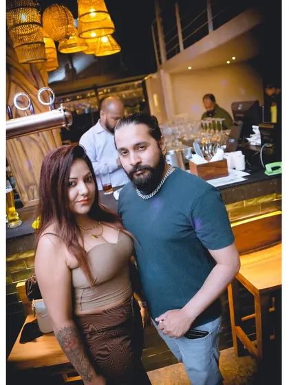 A couple posing at the bar. The venue has a great ambiance for a night out.