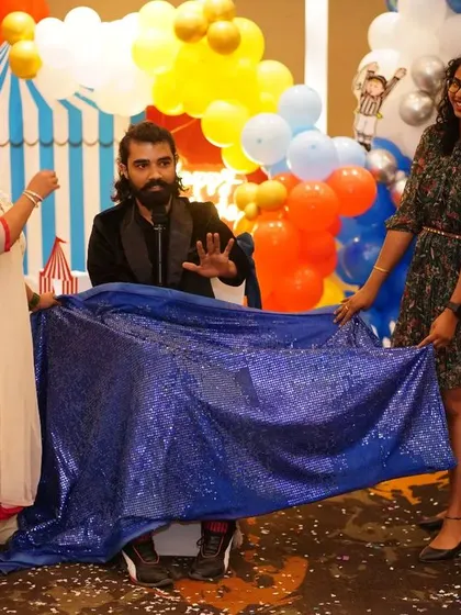 The magic cloth is lifted, and the crowd is amazed.