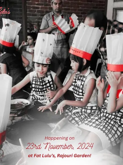 A group of our youngest chefs in their aprons and hats, eagerly waiting for the next step in the pizza making process.
