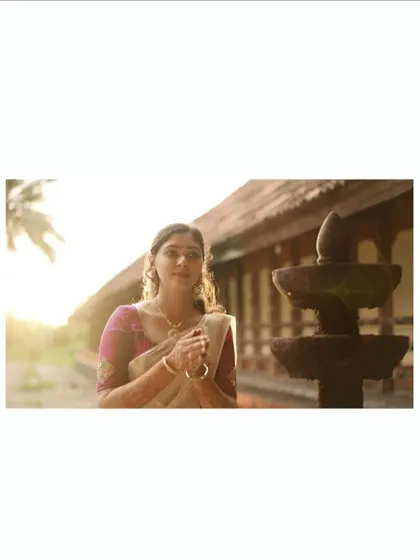 A serene portrait of the bride at sunset, in a traditional setting.