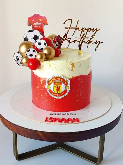 For the ultimate football fan, this Manchester United themed cake is a sure winner. The design features the club's logo and colors, along with edible soccer balls and a jersey.
