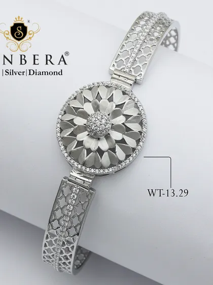 A stunning silver bracelet with a large, textured floral medallion. Weighing 13.29 grams, this is a bold and beautiful piece for celebrating life's moments.