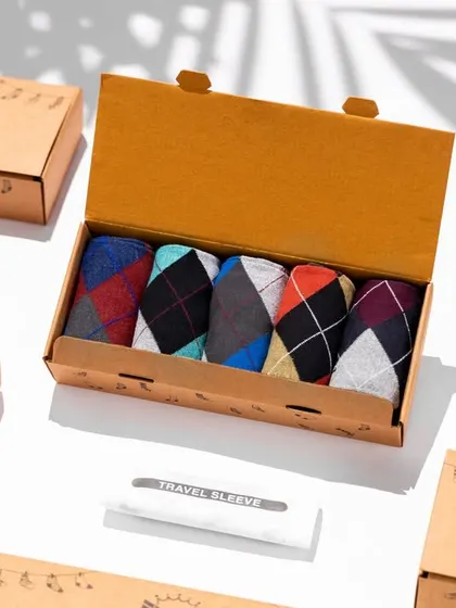 A product shot for Belmonk socks, showcasing their gift box packaging. The clean lighting and subtle shadow from the leaf add a touch of lifestyle feel to this e-commerce shot.