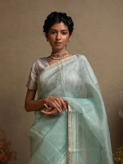 A full view of the blue organza saree, showcasing its sheer beauty and intricate craftsmanship.