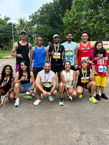 Celebrating with my running crew after the Mysuru Half Marathon. Sharing these moments of success with friends makes the victory even sweeter.