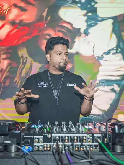 In the middle of a mix at Boche Club, fully focused on the music and the crowd's reaction. The background features a custom graffiti-style visual.