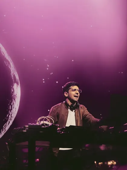 Lost in the music, creating a whole universe of sound. In this shot, you can see the visuals projecting a planet and starry sky behind me, matching the cosmic vibe of the set.