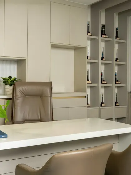 This angle of the MD's cabin shows the seamless integration of the desk, chair, and bespoke shelving unit into a single, cohesive design statement.