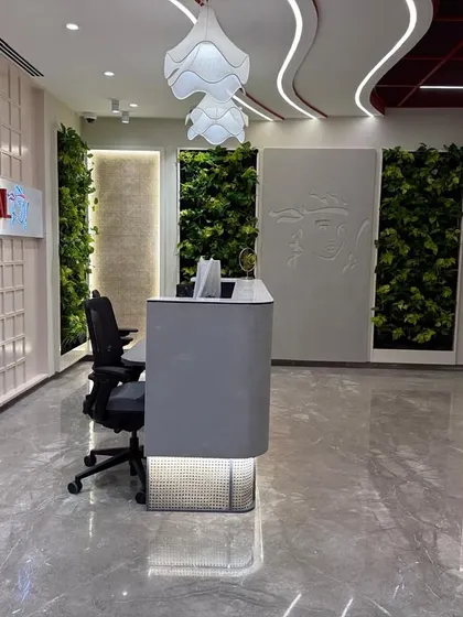 The reception at The Executive Centre for Prudential, where vertical green walls flank the company logo. This is not just decoration; it is a strategic design choice that communicates a brand ethos centered on wellness and sustainability.