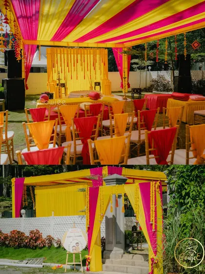 The vibrant pink and yellow decor for a Haldi ceremony, showing the entrance and main seating area.