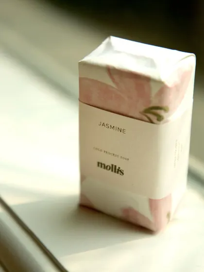 A single Jasmine soap, wrapped and ready for the baby announcement, captured in the soft morning light.