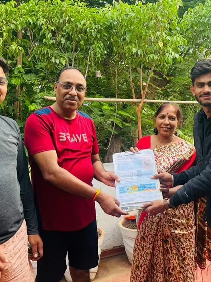 Our team hands over the solar agreement to a happy family in their garden.