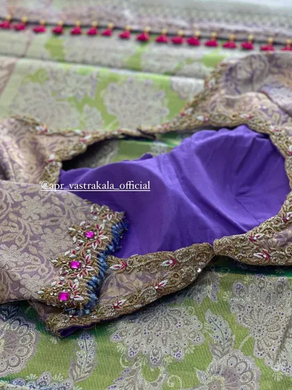 A purple blouse with brocade sleeves, featuring pink and blue stone work.