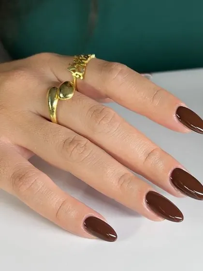 A rich, chocolate brown polish on long almond nails. This is a chic and trendy alternative to classic black or red.
