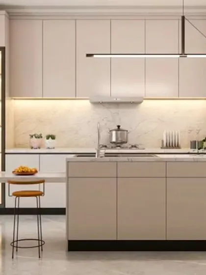 This elegant kitchen design features light beige, handle-less cabinets and a spacious island with a breakfast bar. A glass-front display cabinet with internal lighting adds a touch of sophistication.
