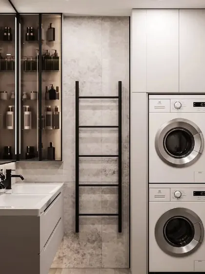 We also design functional utility and laundry spaces. This bathroom includes a stacked washing machine and dryer, along with plenty of storage, all neatly integrated.