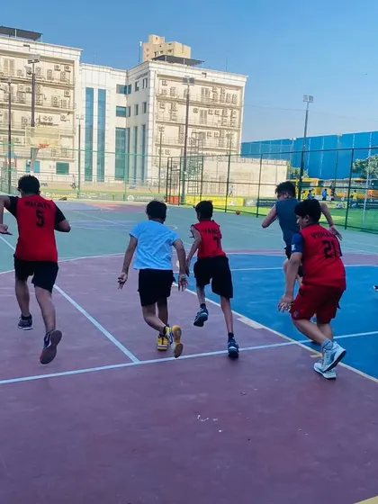 Players running laps as part of their warm-up, building cardiovascular fitness.