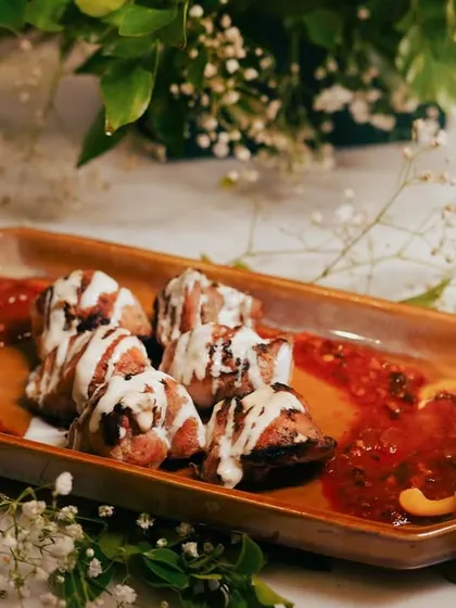 My Chicken Mullayam Kebab is a true masterpiece. The chicken is exceptionally tender and served on a bed of spicy red sauce with a cooling cream drizzle, creating a perfect balance of flavors.