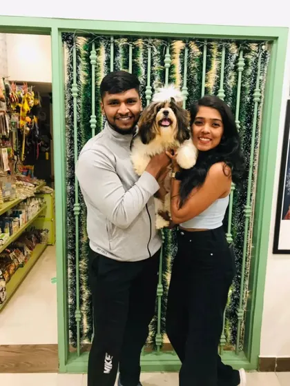 This happy couple is thrilled with their Shih Tzu's fresh look. A clean pet makes for happy pet parents!