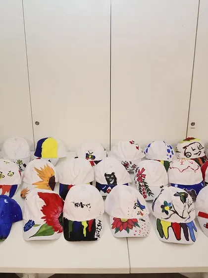 A closer look at the amazing, colorful caps painted by the kids during the HBC workshop. Their imagination truly has no limits.
