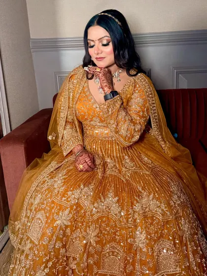 A full-length shot of the bride in a stunning mustard-yellow Anarkali, looking regal and ready for her engagement.