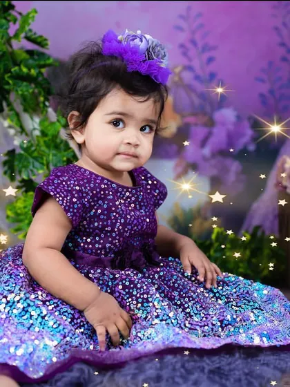 A serene portrait of the birthday girl in her shimmering dress. The added star effects give this photo an extra touch of magic.