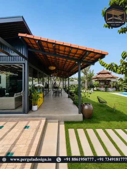 An expansive patio covered by a long, tiled-roof pergola, overlooking a beautiful lawn and pool. This is the ultimate outdoor entertainment space, offering ample shade and a resort-like feel.