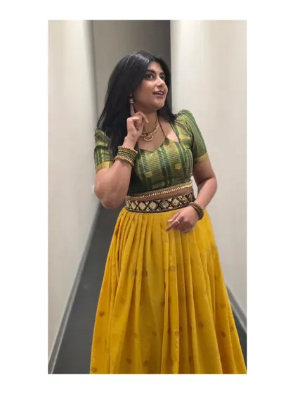 A bright and cheerful yellow and green lehenga. This outfit is full of energy, just like the songs I love to sing for festive occasions.