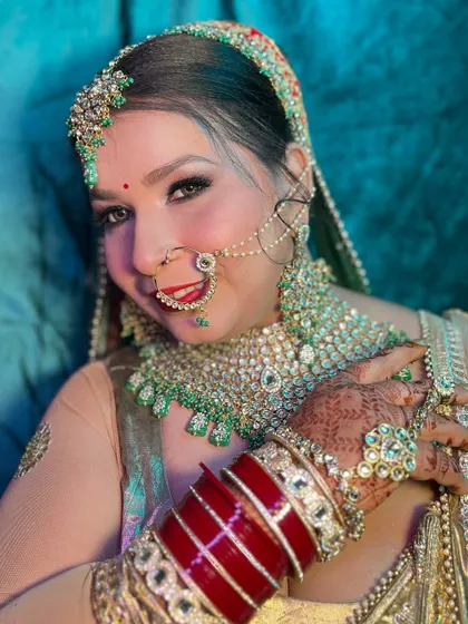 A close-up of this happy bride, showing off her flawless makeup, sparkling eyes, and the intricate details of her bridal jewelry.