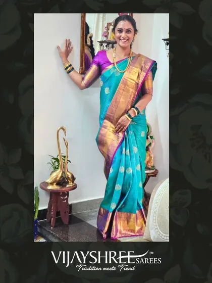 Anju looking beautiful in a sky blue Kanjivaram with a rich purple and gold border.