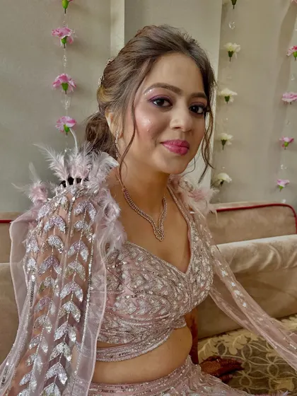 This bride's reception look is a balance of playful hues and refined elegance, with shimmering lids and a radiant glow.