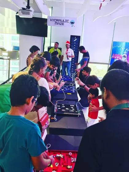 A crowd gathers around our hydraulic and electric maze games at a corporate Christmas party. The variety of challenges keeps the engagement level high throughout the event.