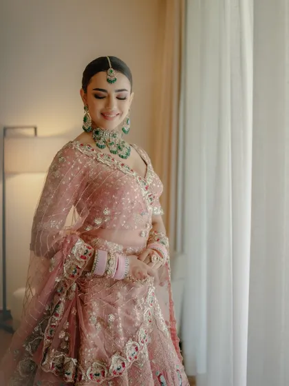 A candid moment of my bride glowing by the window. The natural light beautifully highlights her radiant skin and the soft tones of her makeup.