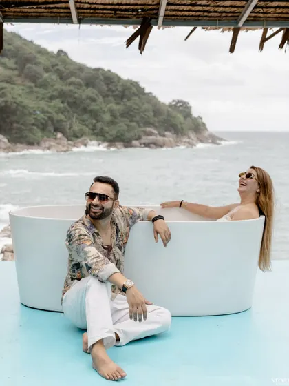 Laughter and joy with an ocean view in Phuket. This image perfectly captures the fun and relaxed atmosphere of a beachside pre-wedding shoot.