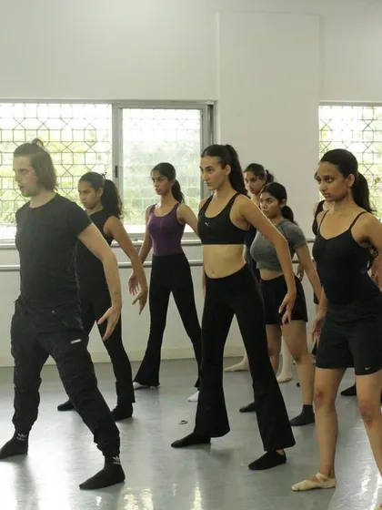 Learning choreography during a jazz workshop. Students work on mastering dynamic movements and stage presence, key skills for any aspiring performer.