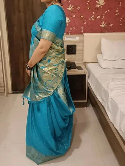 A side view of the pre-pleated Gujarati drape. This angle shows how the pleats are structured and how the front pallu falls, creating the signature look of this regional style.