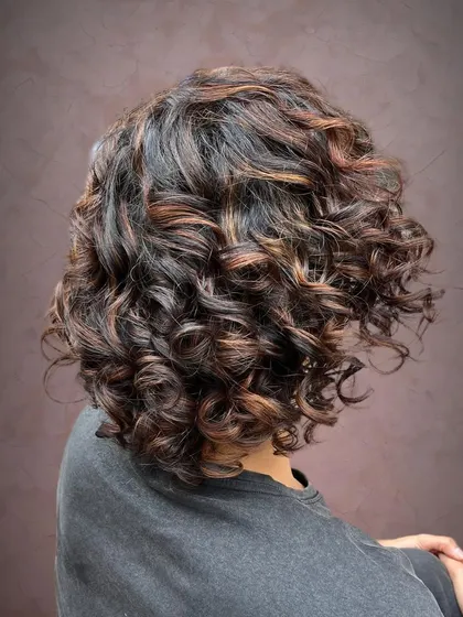 A side view showing how the pintura highlights accentuate her curls.