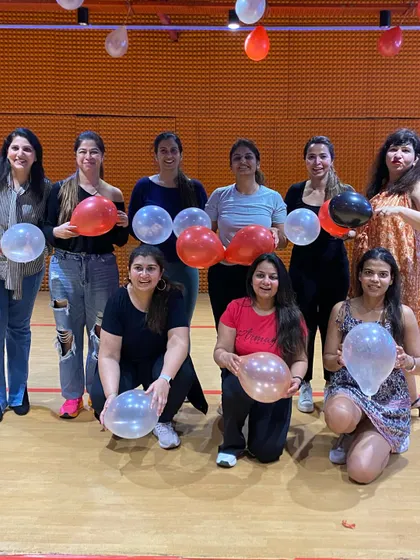 Our ladies' group posing with balloons during a celebration. Every day is a reason to celebrate at Zink.