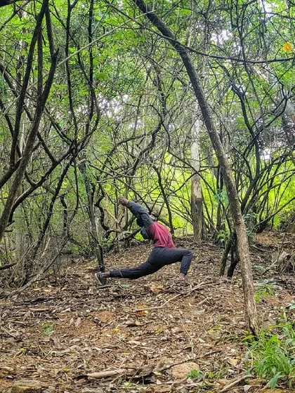 A dynamic lunge in the middle of a forest. The tangled branches all around feel like a metaphor for life's complexities, and the pose is a moment of finding clarity within it.