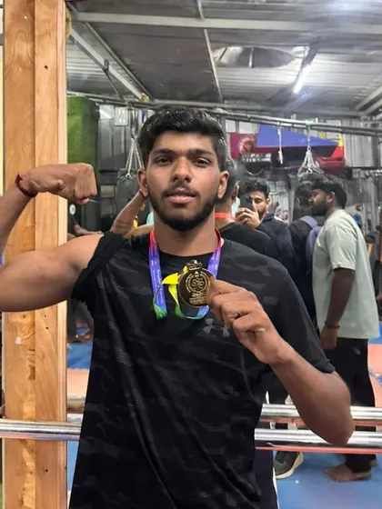 A champion's pose. This fighter's hard work paid off with a gold medal in university-level boxing.