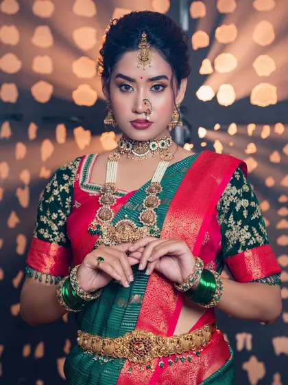 A full portrait showcasing the complete look. The makeup, jewellery, and saree all come together to create a powerful and elegant statement for this South Indian bride.