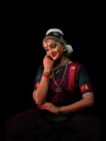 A seated pose capturing a moment of quiet introspection and subtle emotion. The focus is on the delicate expression and mood.