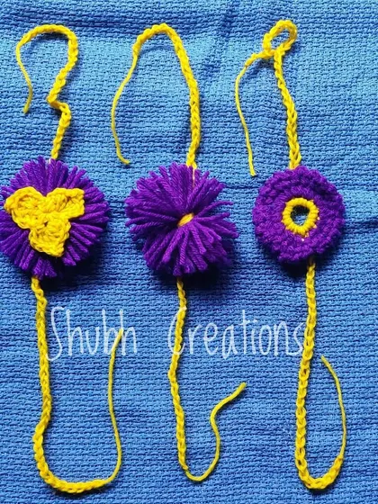 A trio of purple and yellow rakhis, showcasing different techniques like floral patterns and pompom centers.