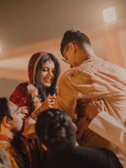 The 'saat paak' ritual in a Bengali wedding, where the bride is lifted by her brothers and circles the groom. A moment of fun, tradition, and family participation.