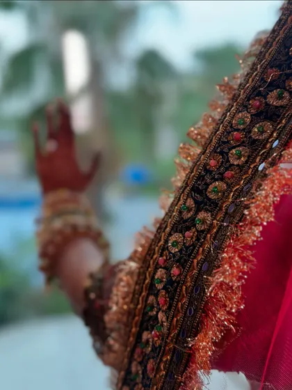 A close-up on the details. The intricate embroidery on the border of the dupatta is a work of art. It's these small elements that make a bridal outfit truly special.