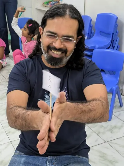 A parent volunteer smiles as he demonstrates a playful science experiment to the children. We believe in harnessing the expertise within our parent community to enrich our curriculum.
