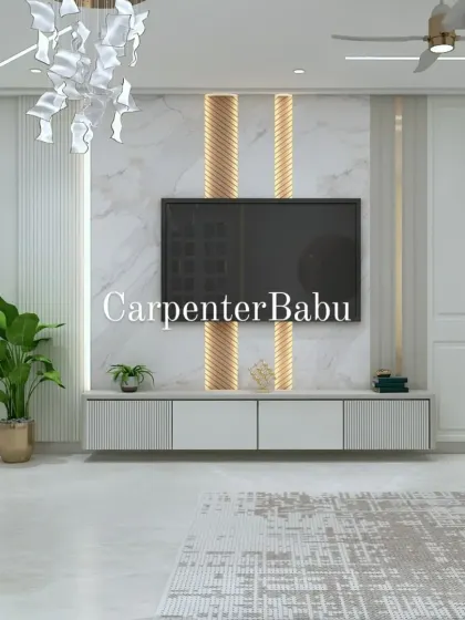 A modern TV unit with a marble back panel and gold-accented fluted columns. The abstract chandelier adds a sculptural element to this elegant living room.