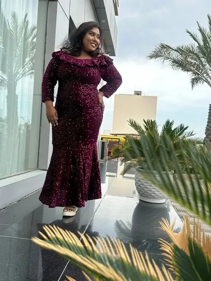 Another angle of the sequined gown, with palm trees in the background giving it a resort-like feel.