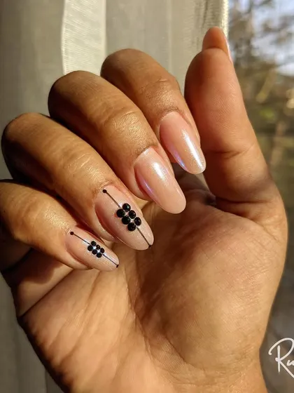 A minimalist design featuring black crystal accents on a pearlescent nude base. The clean lines and geometric placement give this look a modern edge.