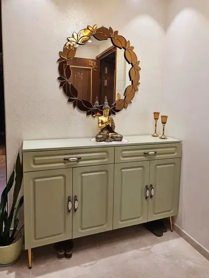 This elegant shoe cabinet in a serene sage green PU finish provides ample storage while serving as a beautiful console table for the entryway. The custom design keeps footwear hidden and the entrance tidy.